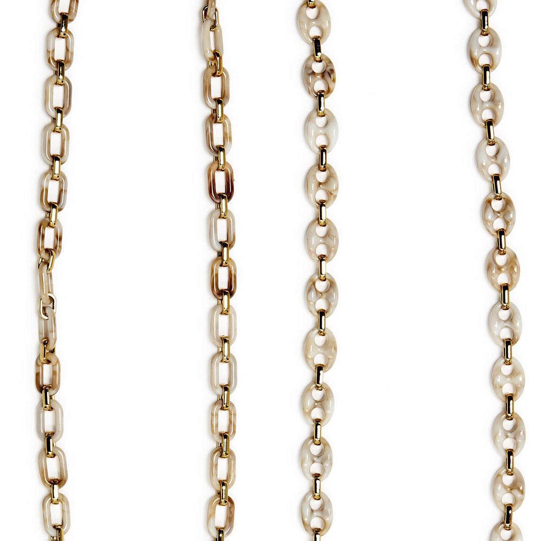 Gold and pearl chain necklace on a white background