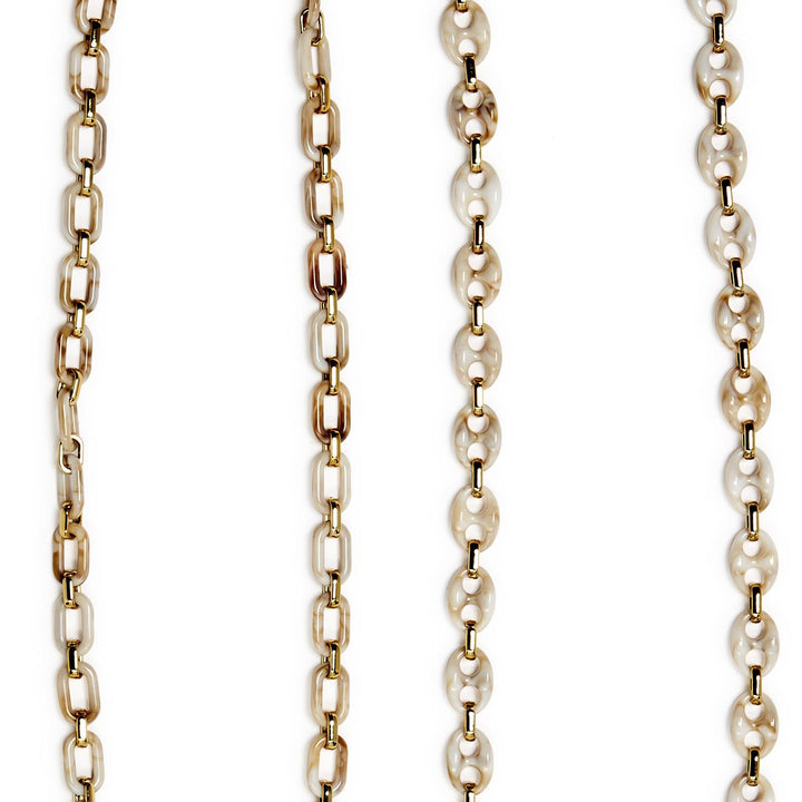 Gold and pearl chain necklace on a white background