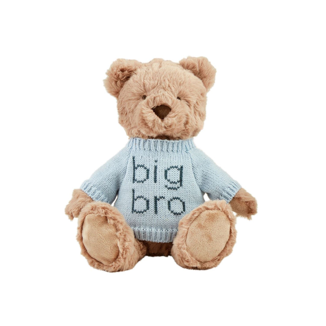 A beige teddy bear with a blue knit sweater that says 'big bro' on it, sitting against a white background.