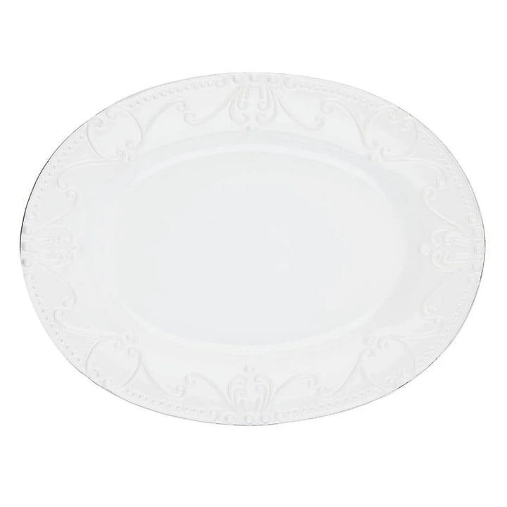 Round white plate with subtle pattern on a white background
