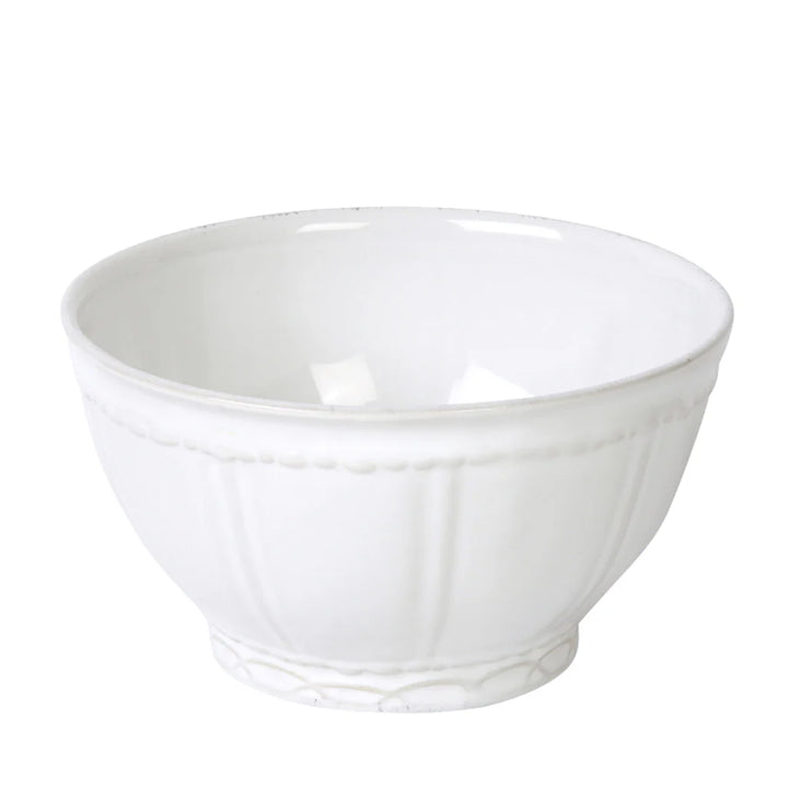 A white ceramic stoneware dinner plate with a textured rim.