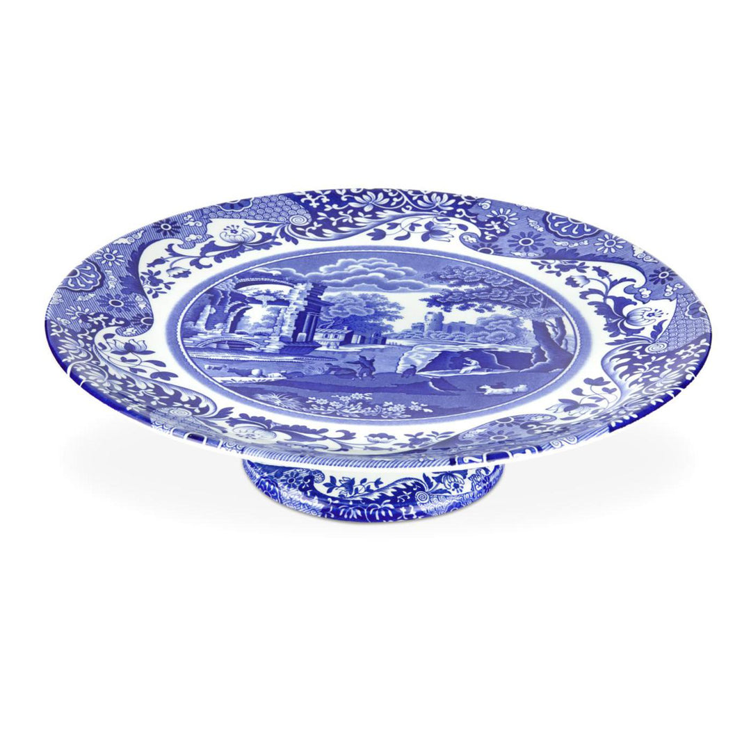 A footed cake plate with blue floral patterns on fine porcelain.