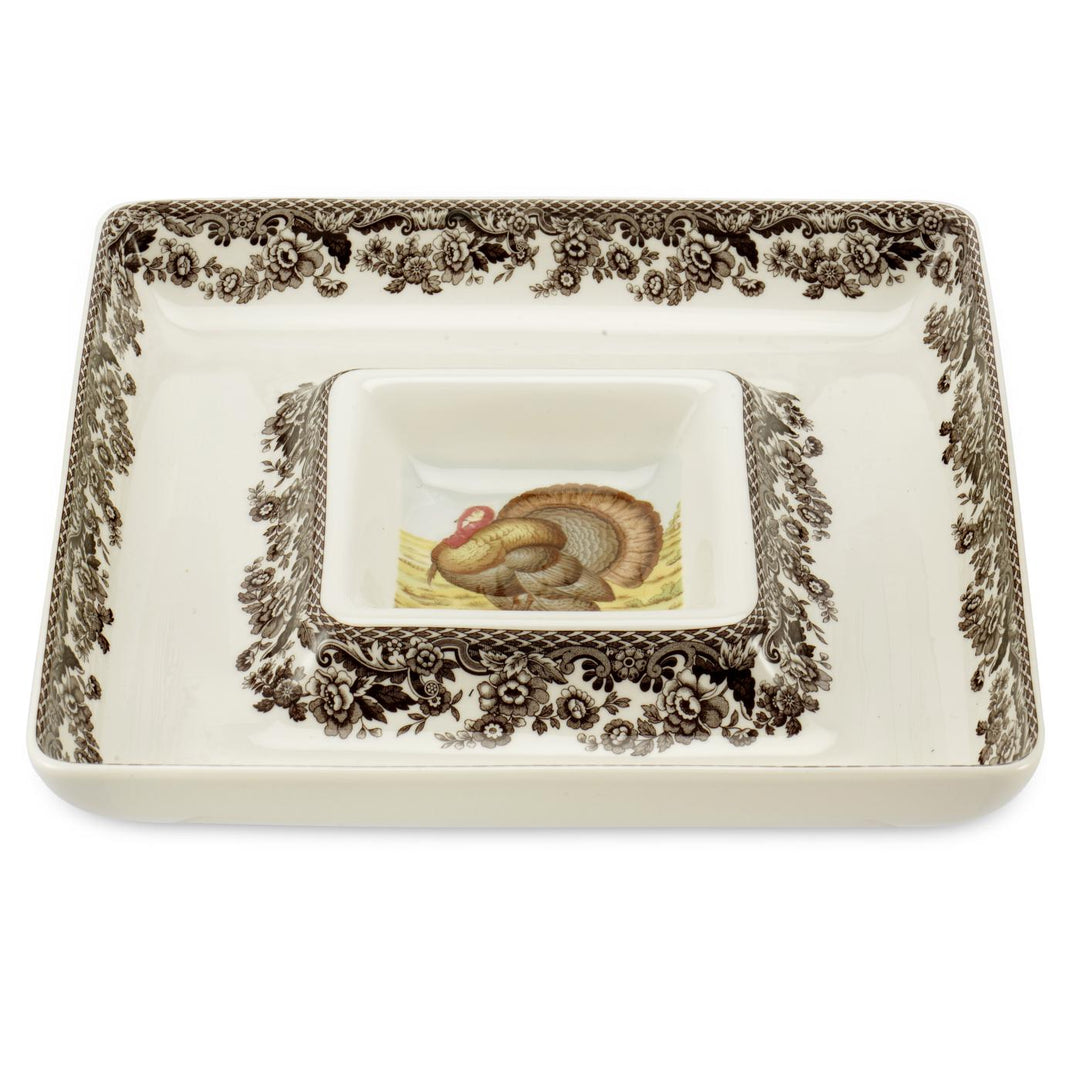 A square white porcelain chip and dip serving plate with brown floral patterns and a central turkey illustration.