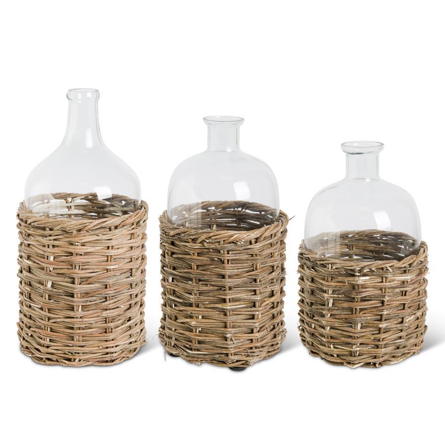 CLEAR GLASS BOTTLE IN RATTAN BASKET