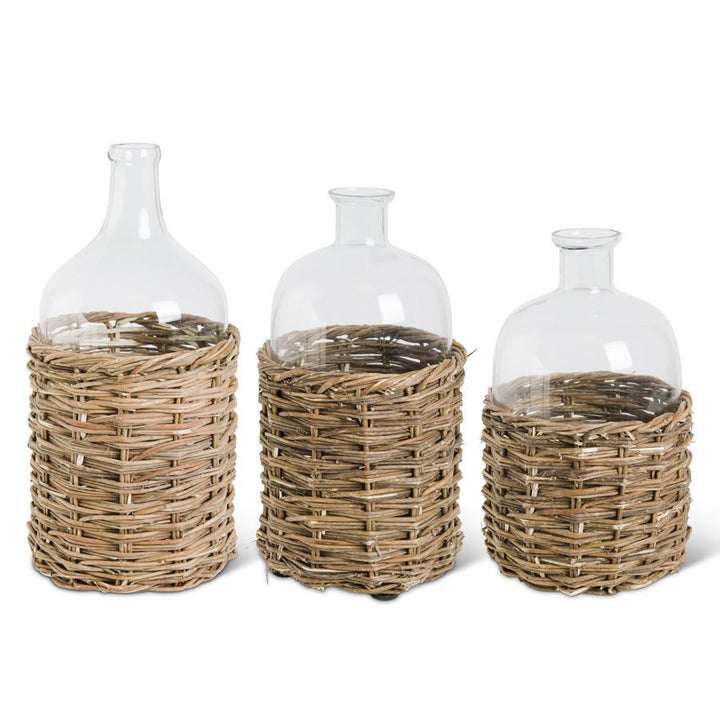 CLEAR GLASS BOTTLE IN RATTAN BASKET