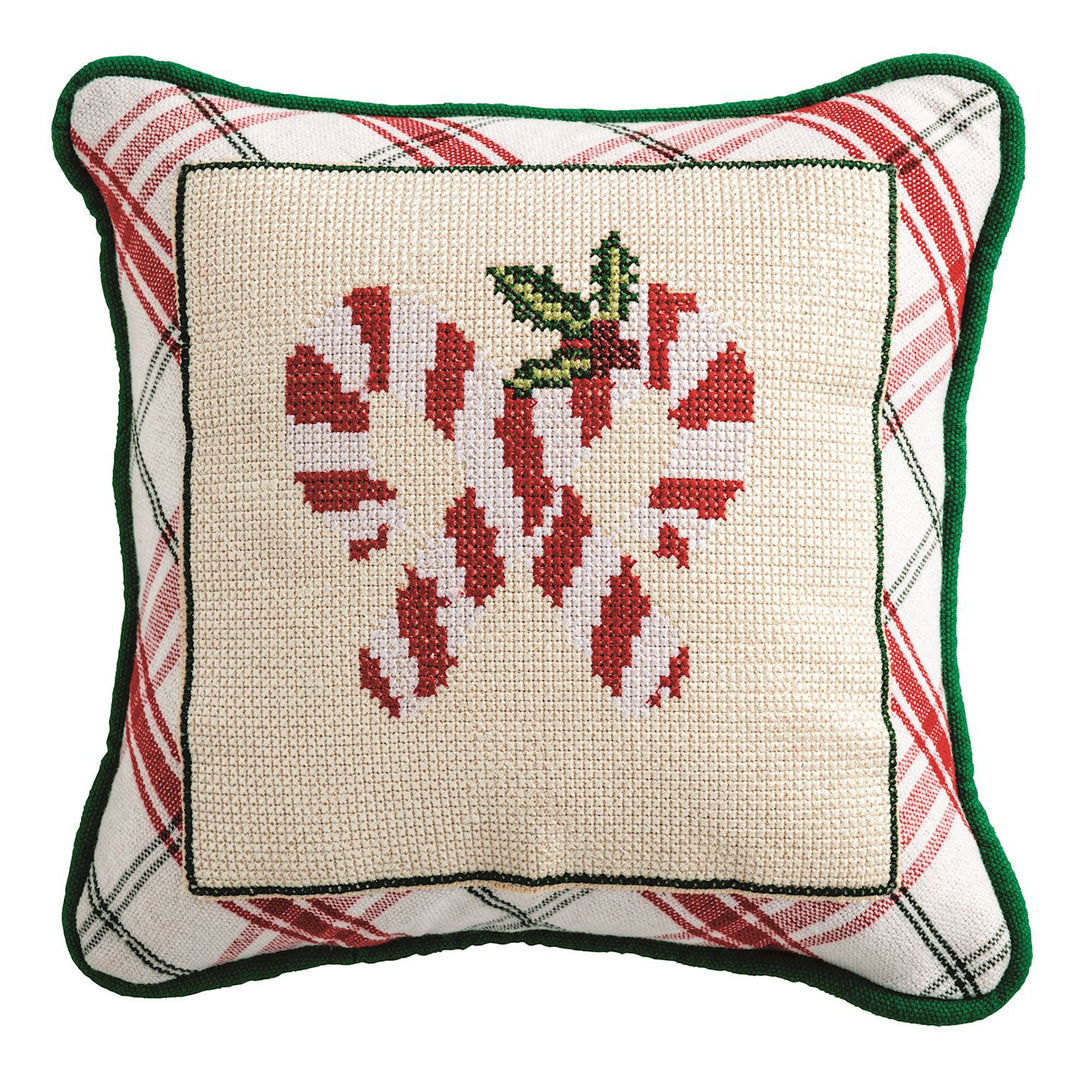Woven cotton pillow features needlepoint panel and piped edge.