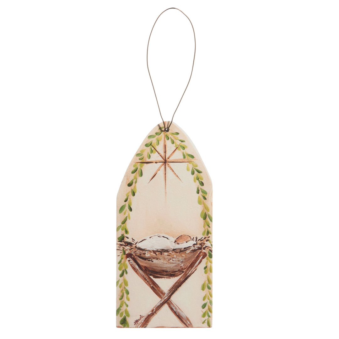 baby in a manger on ornament on white background