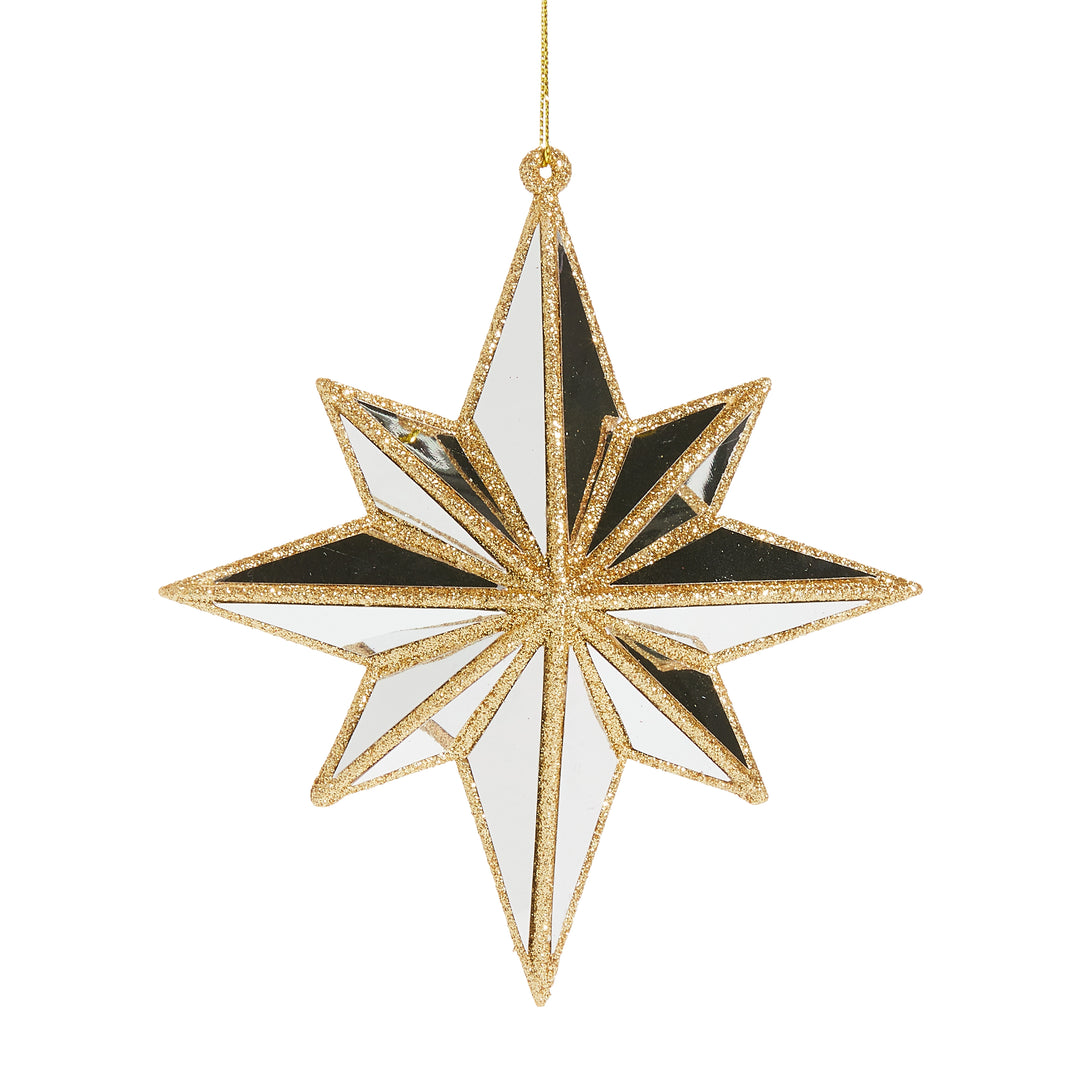 Decorative star ornament with gold, black, and white design on a white background