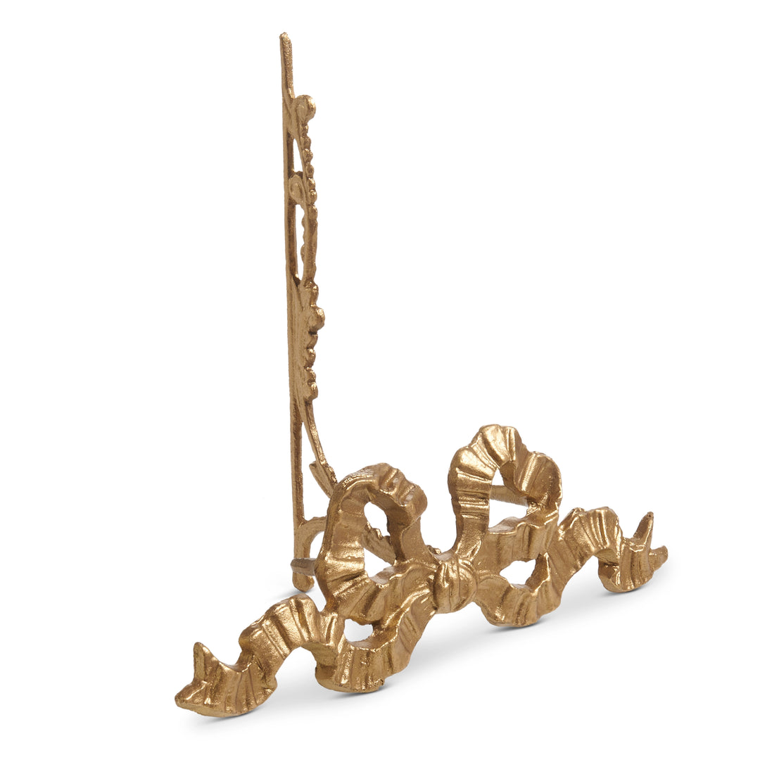 Decorative gold object with intricate design on a white background