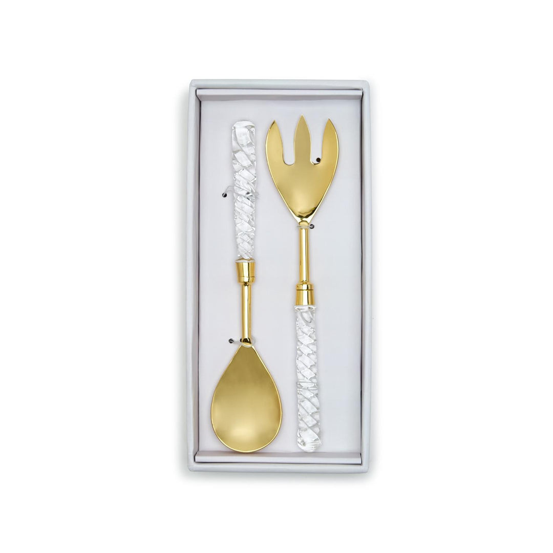Gold spoon and fork set in a white box on a white background