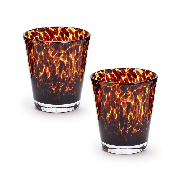 Two tortoiseshell patterned glass tumblers on a white background