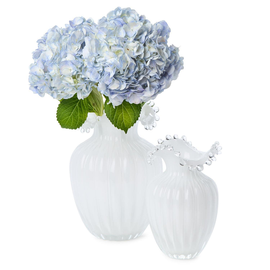 Clear glass vase with blue hydrangeas on a white background