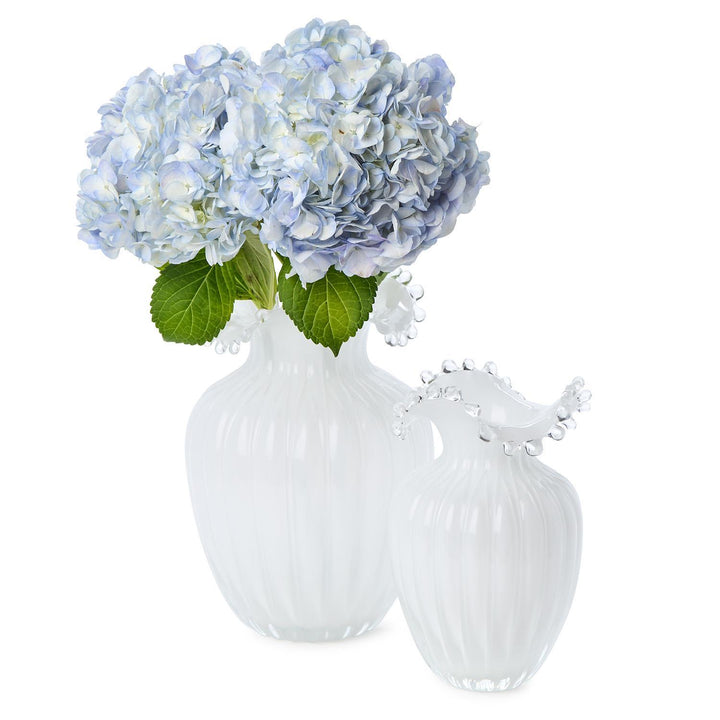 Clear glass vase with blue hydrangeas on a white background
