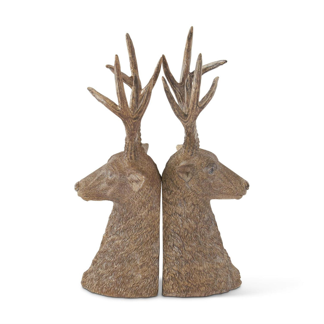 Two deer head sculptures with antlers on a white background