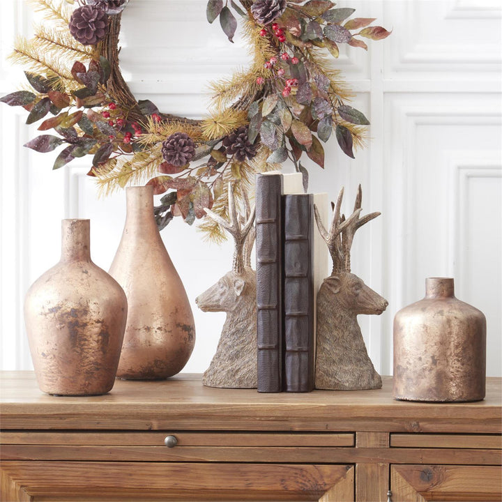 Decorative items including vases, bookends, and a wreath on a wooden surface.