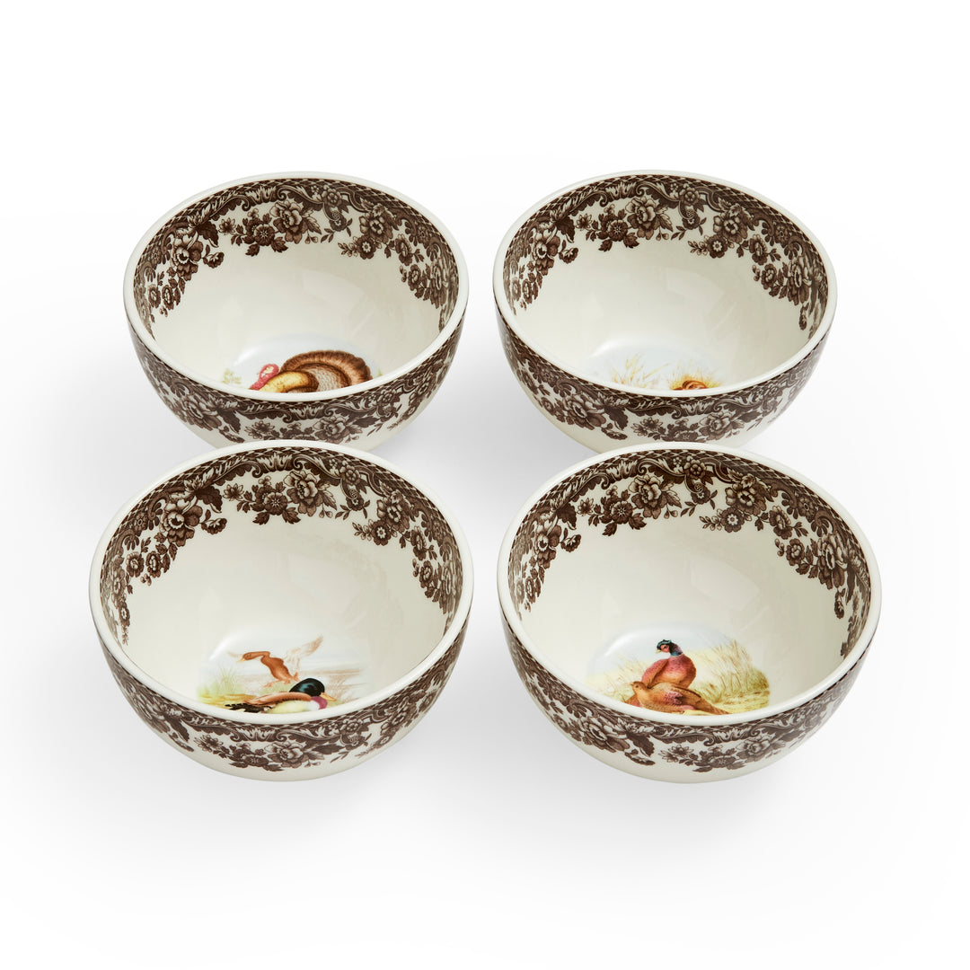 A set of four porcelain bowls with woodland bird motifs in brown and white colors.