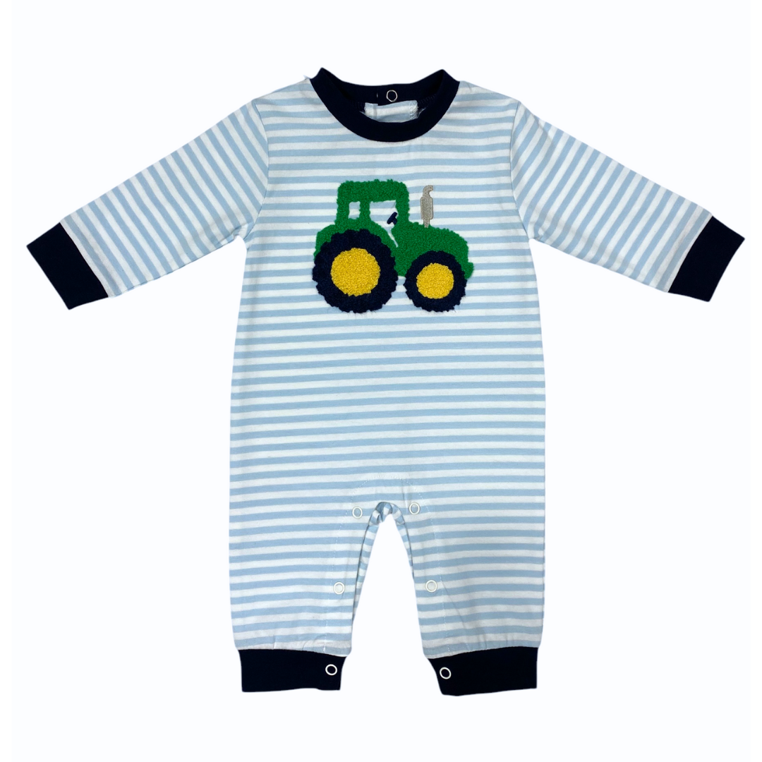 Striped baby romper with a green tractor design on a white background