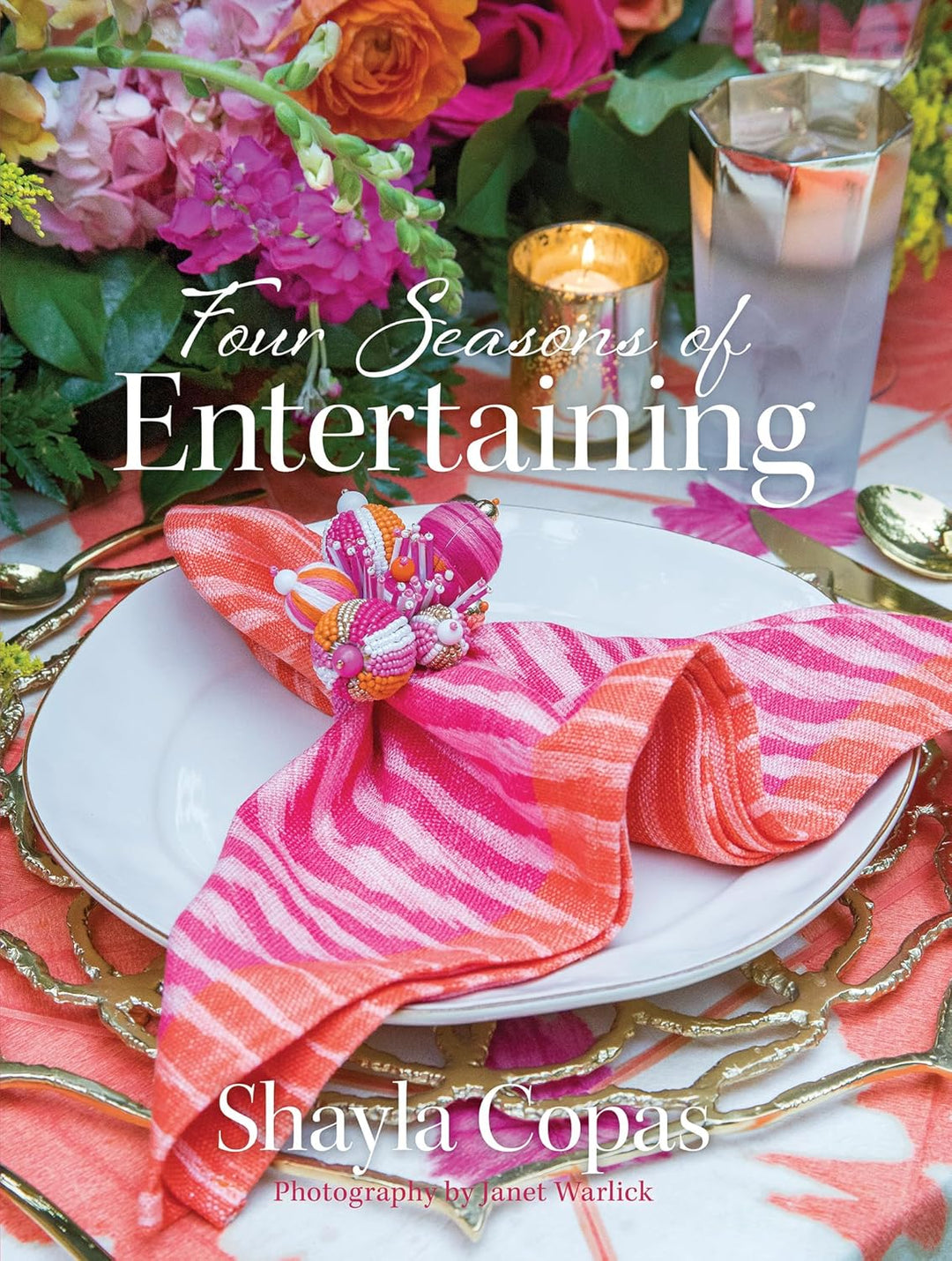 Table setting with pink napkin, flowers, and candles on a tablecloth with 'Four Seasons of Entertaining' text.