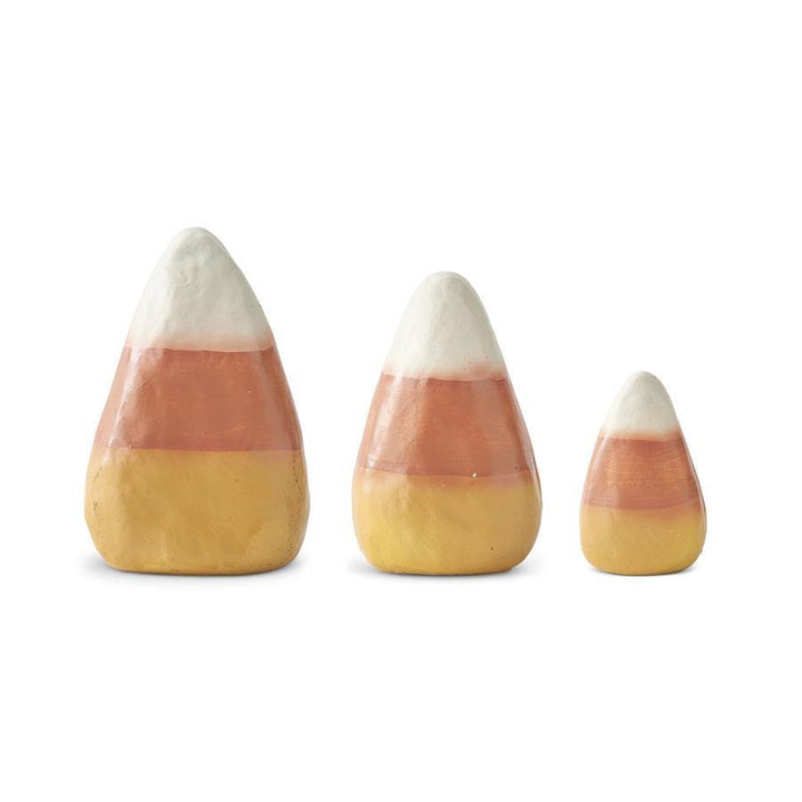 Three candy corn-shaped salt and pepper shakers on a white background