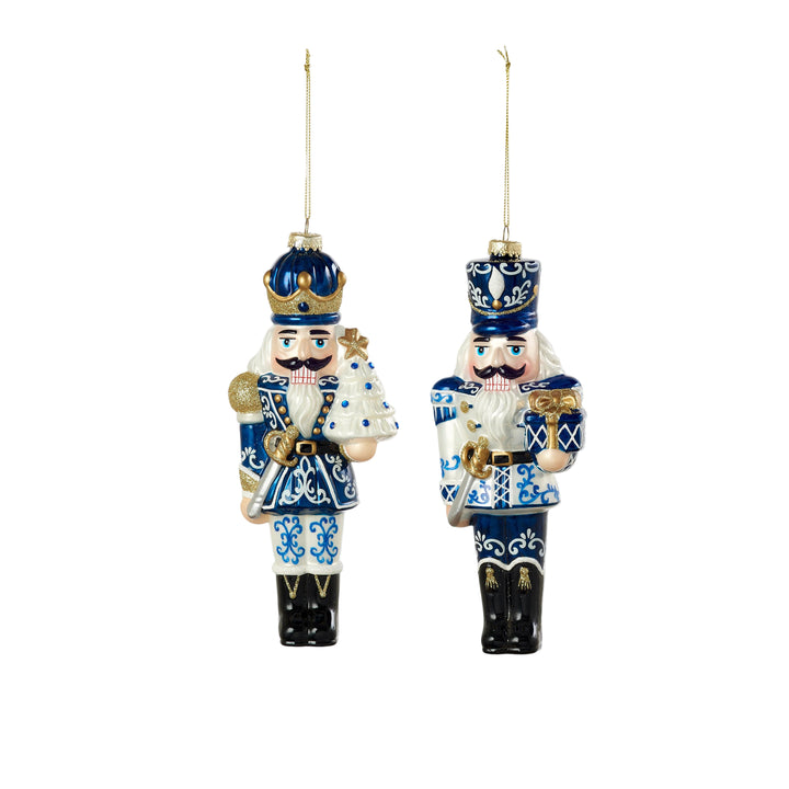 Two nutcracker ornaments with blue and white patterns on a white background