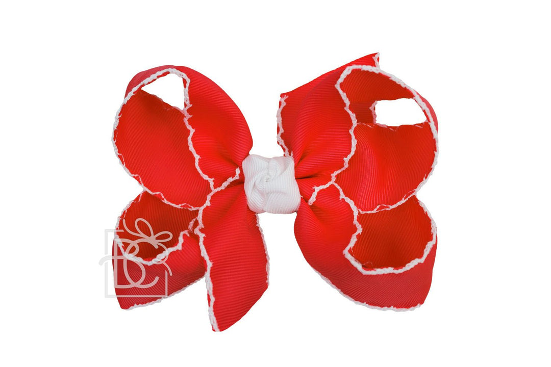 red bow with white trim edges
