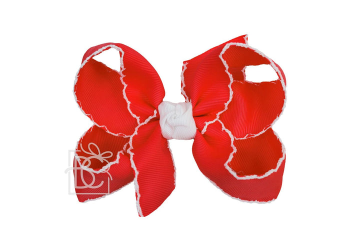 red bow with white trim edges