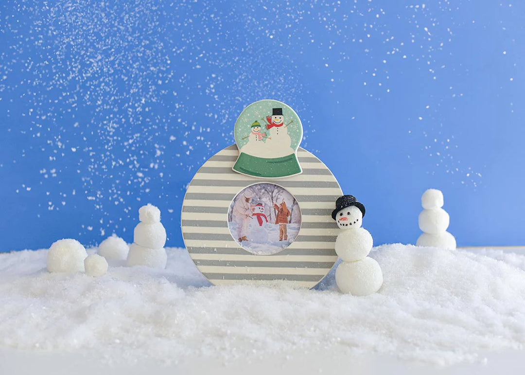 Snow globe with snowmen and a blue sky background