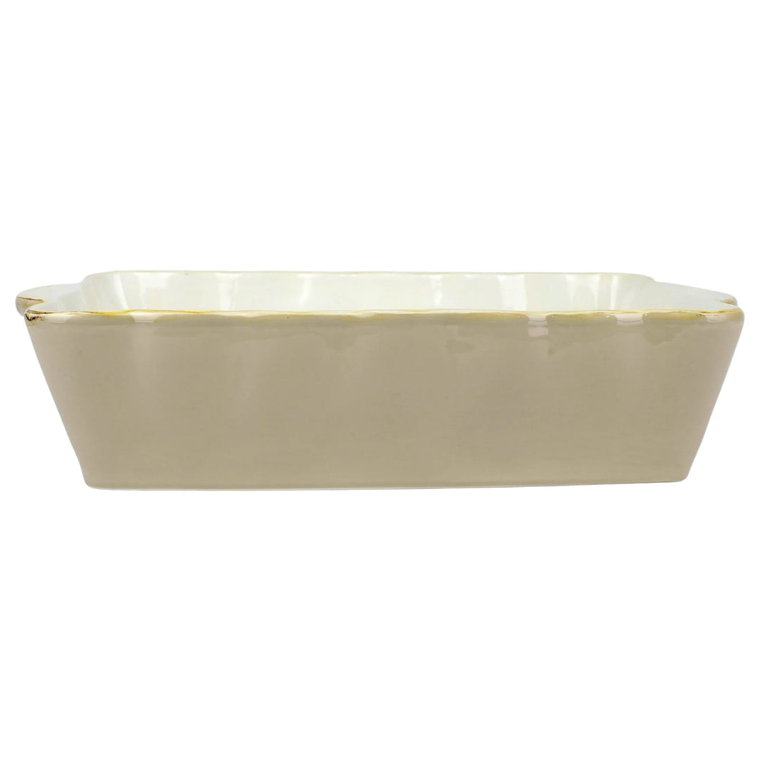 A rectangular Italian stoneware baker with scalloped edges and a gold rim.