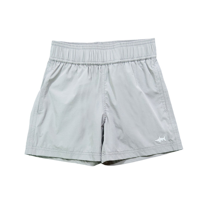 A pair of grey performance shorts for boys, with a small shark graphic on the left leg.