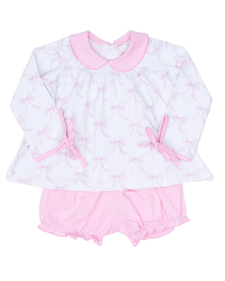 Baby girl's outfit with long-sleeve top and pink bloomers on a white background