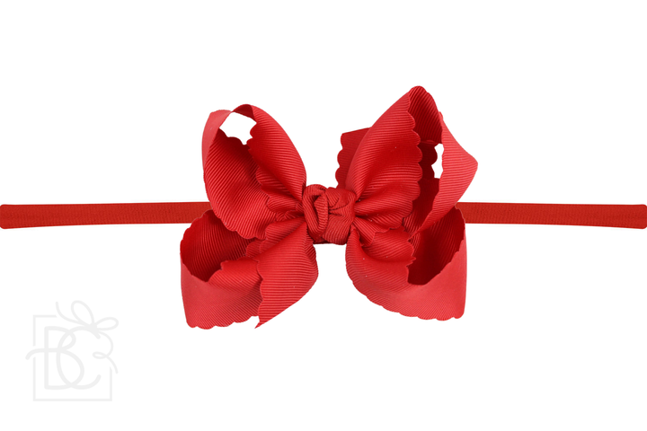 A red scalloped edge pantyhose headband with a bow