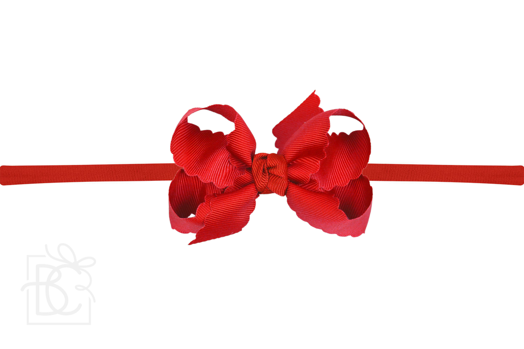 A red scalloped edge pantyhose headband with a bow