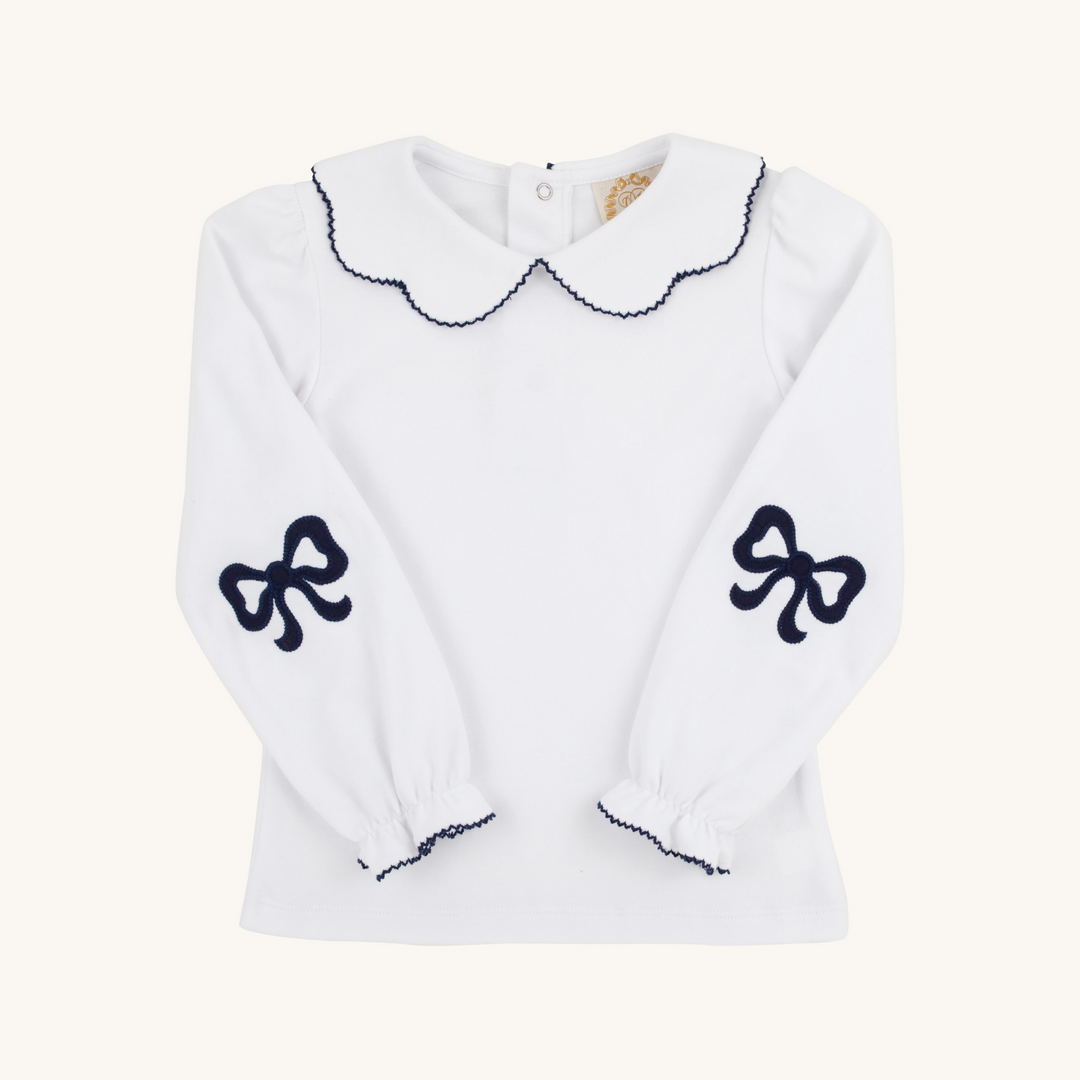 White sweater with black bow designs on a white background