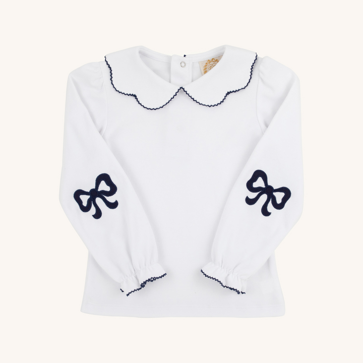 White sweater with black bow designs on a white background
