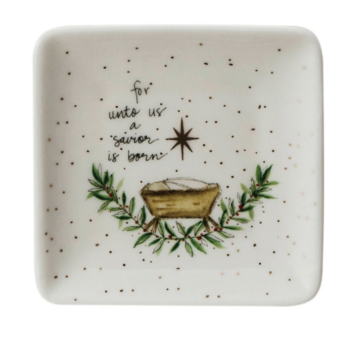 Decorative plate with Christmas design featuring a manger scene and text on a white background.