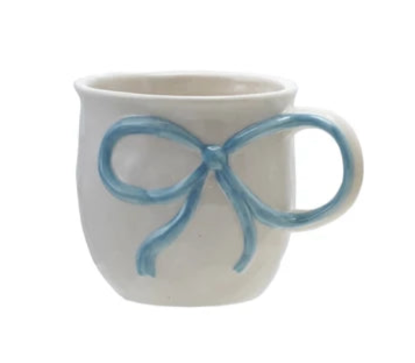 White mug with a blue bow design on a white background