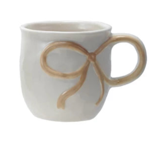 White mug with a brown bow design on a white background