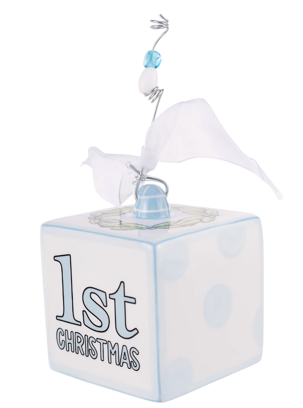 Decorative cube with '1st Christmas' text and baby booties on a white background