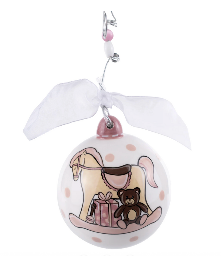 Decorative ornament with a rocking horse and teddy bear design on a white background