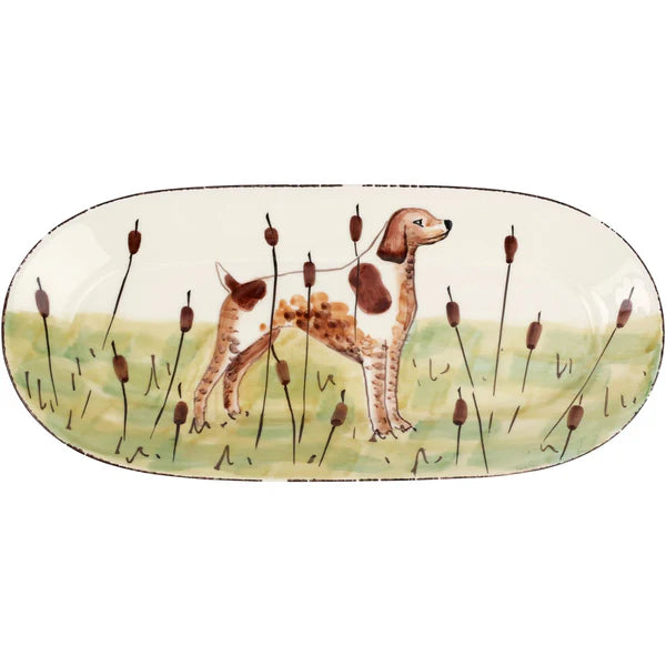Decorative plate with a dog and cattails design on a white background