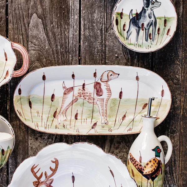 Collection of ceramic plates with animal designs on a wooden surface