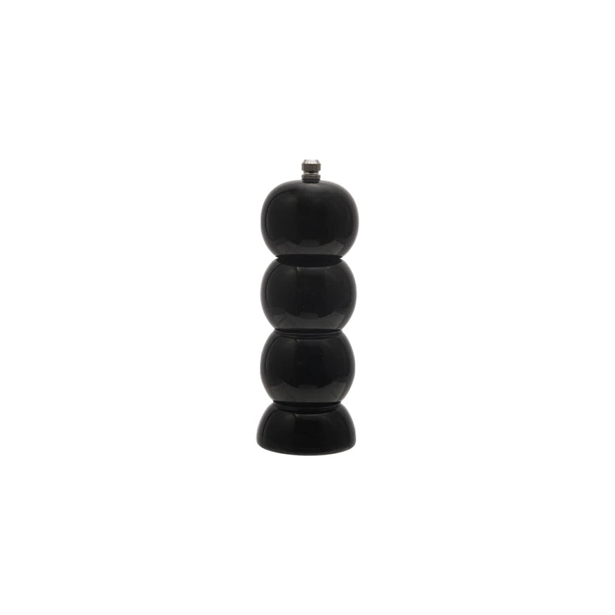 Black pepper grinder on a white background