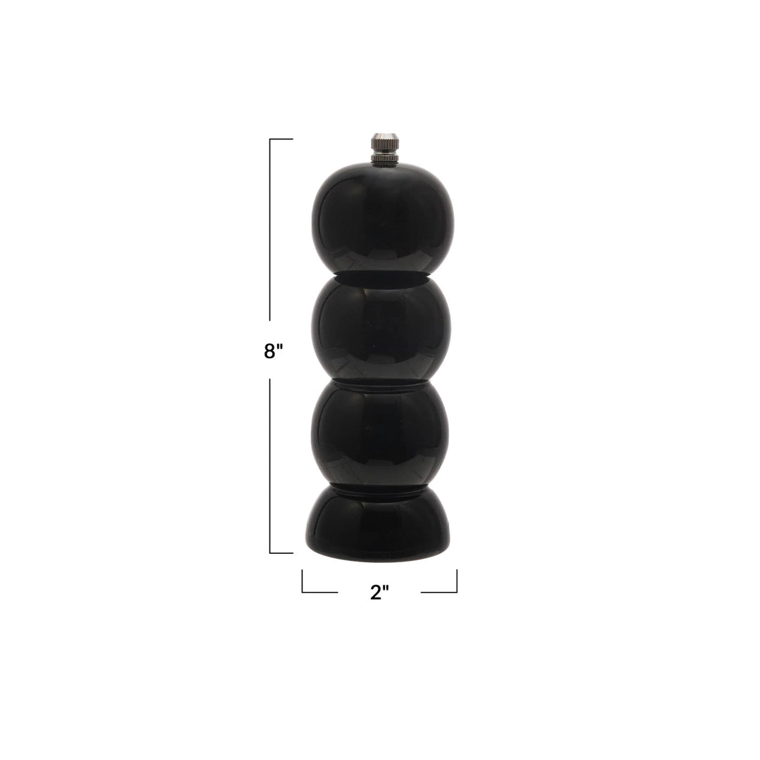Black pepper grinder with measurements on a white background