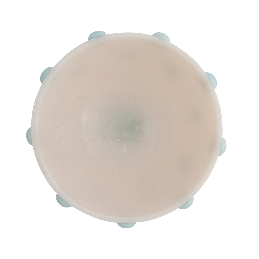 Round beige object with blue accents on a white background