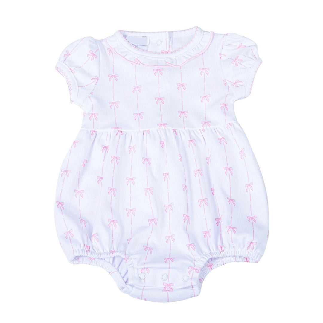 White baby romper with pink bow pattern on a white background