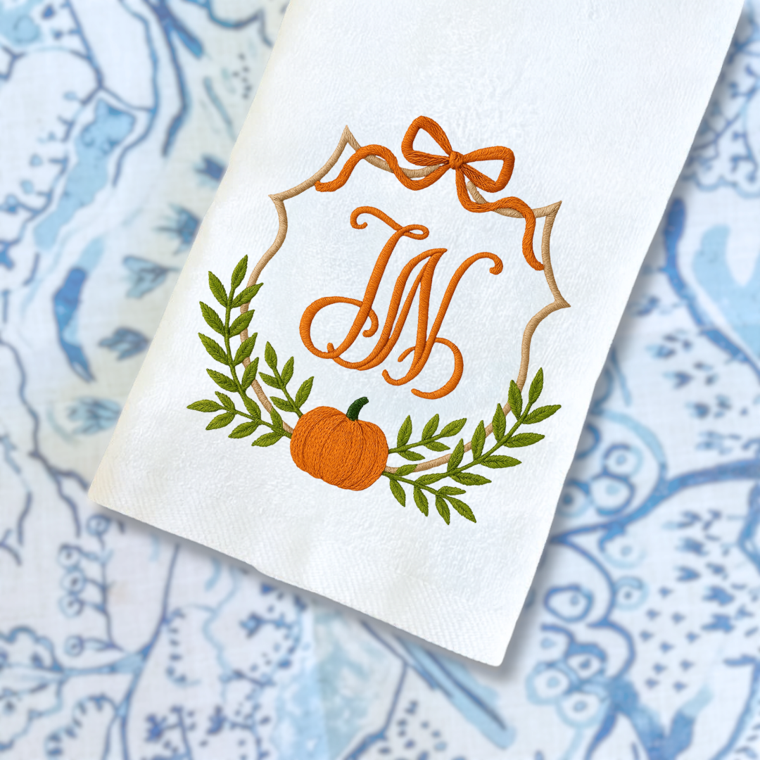 embroidery design on hand towel with W and crest with pumpkin and greenery