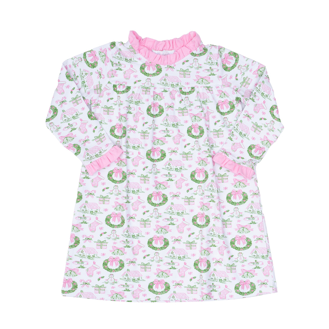 Children's dress with pink and green holiday toile pattern on a white background