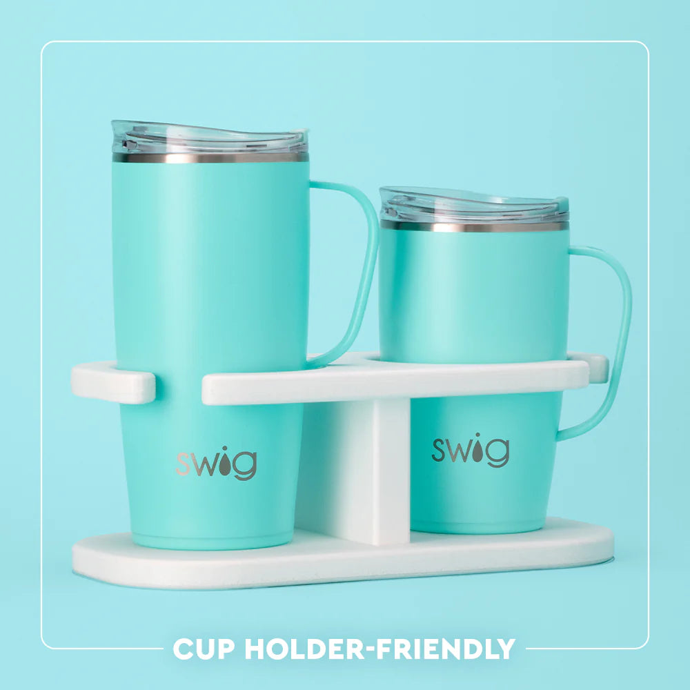 Two turquoise mugs with a white stand on a light blue background, featuring the 'swig' brand.