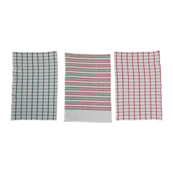 Three kitchen towels with different patterns on a white background
