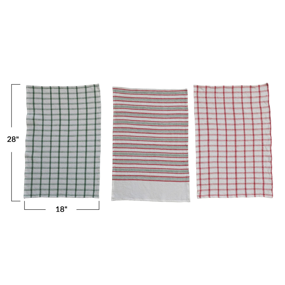 Three fabric towels with different patterns and measurements on a white background